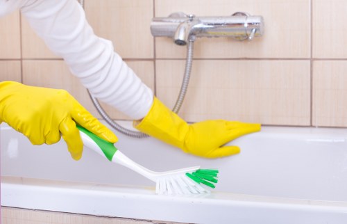 Professional London cleaner wiping kitchen surfaces