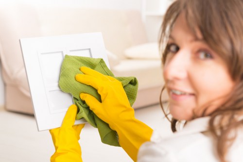 Professional office cleaner vacuuming carpets in a London workspace
